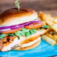 Grilled Salmon Sandwich  · Citrus honey glazed grilled Salmon on a toasted bun with arugula, sliced tomato, red onions ...