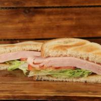 Turkey Sandwich · Thinly sliced turkey topped with crisp iceberg lettuce, ripe tomato, and freshly sliced onion.