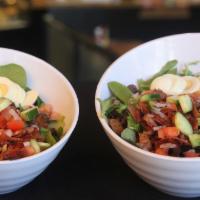 Cobb Salad · Mixed greens, tomato, cucumber, and red onion, topped with crispy bacon and hard boiled egg,...