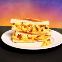 Bacon Mac And Cheese Melt Sandwich · Mac and cheese with crispy bacon sandwiched between two slices of toasted white bread.