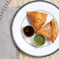 Vegetable Samosa (2 Pcs.) · 2 turnovers filled with peas and potatoes served with tamarind chutney.