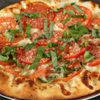 Napoli · House-made roasted garlic sauce, mozzarella, roma tomatoes, Parmesan, fresh basil.