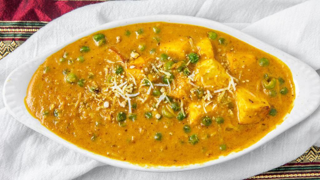 Kerau Paneer (Mattar Paneer) · Green peas are cooked in a gravy of onion and tomatoes along with herbs and spices with homemade cheese cubes.