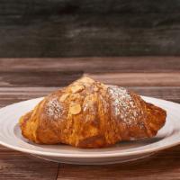 Chocolate Croissant · A flaky, buttery croissant encircling a melted stick of chocolate. Topped with almonds and a...