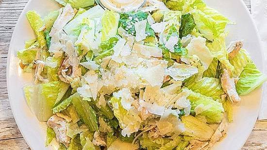 Chicken Caesar Salad · Romaine lettuce, pita croutons, and shredded chicken breast, tossed with Maison Caesar dressing and topped with fresh parmesan cheese.