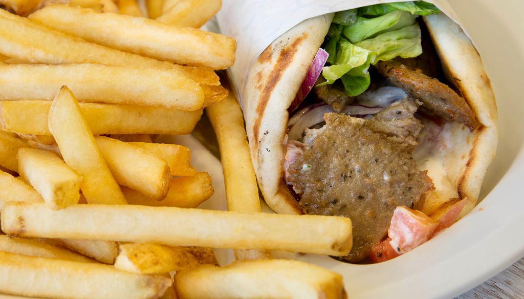 Spicy Gyro Sandwich · Tender and juicy gyro hot off the spit, topped with lettuce, tomatoes, onions, and tzatziki sauce, all wrapped in a warm flatbread.
