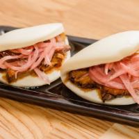 Pork Buns (2 Pieces) · Steamed buns, marinated pork belly, pickled onions, hoisin sauce.