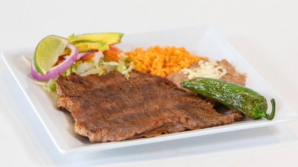 Ranchera A La Plancha · Flap steak served with  a side of rice and beans.
3 Handmade tortillas.