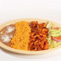Camarones A La Diabla · Spicy Shrimp in a red sauce served with rice and beans.