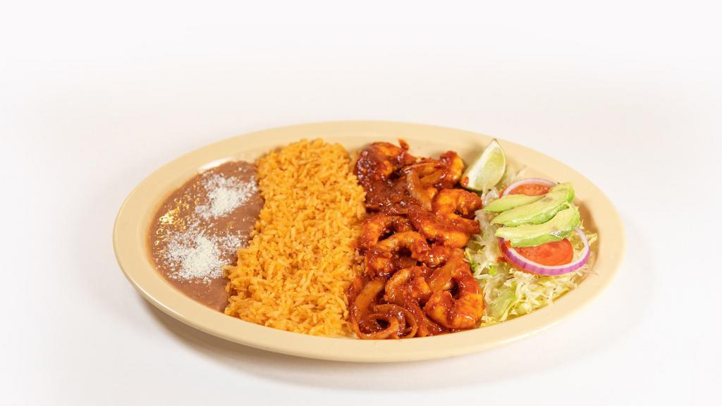 Camarones A La Diabla · Spicy Shrimp in a red sauce served with rice and beans.