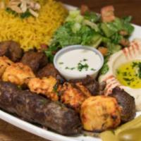 Combo Plate · Chicken, beef & lamb gyro, rice, hummus, Greek salad pita, tzatziki sauce.