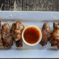 Wood Fired Wings · Pecan smoked wings, lightly coated with salt, pepper and paprika, and then baked in our 800 ...