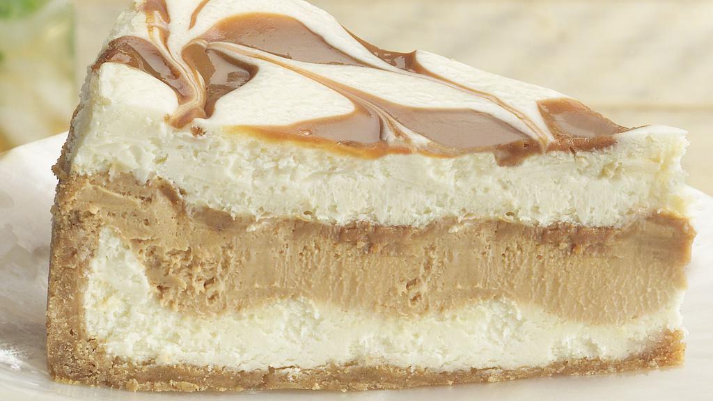Dulce De Leche Cheesecake · Creamy, sweet white chocolate cheesecake marbled and layered with a rich, dulce-flavored cheesecake and pockets of gooey dulce de leche caramel