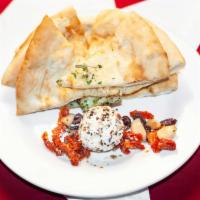 Peppered Goat Cheese · With sun-dried tomato-olive relish, roasted garlic, and herb flat bread.