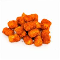 Spiced Potato Tots Side · Crispy potato tots tossed in a medium heat spiced Nashville seasoning blend. Served with a s...