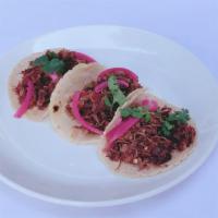 Machaca Tacos · fresh corn tortillas, mexican shredded beer ranchero style, pickled red onion, micro cilantro