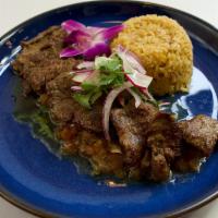 Carne Ranchero · 8 oz ranchero cut, salsa ranchero, served with house rice and beans and fresh corn tortillas