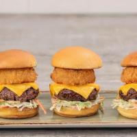 All American Sliders · Three mini-burgers with melted American cheese, crispy onion ring and creamy coleslaw on a t...