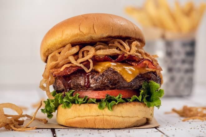 Bbq Bacon Cheeseburger · Steak burger, seasoned and seared with a signature spice blend, topped with house-made barbecue sauce, crispy shoestring onions, cheddar cheese, applewood bacon, leaf lettuce, and vine-ripened tomato served with seasoned fries.
