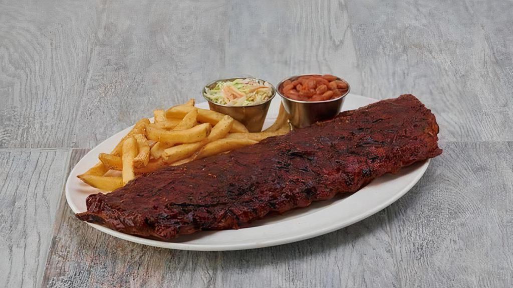Baby Back Ribs · Seasoned with our signature spice blend, then glazed with our house-made barbecue sauce and grilled to perfection, served with seasoned fries, coleslaw, and ranch-style beans.