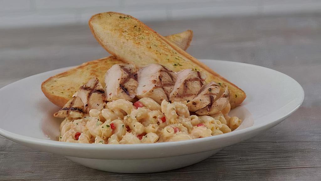 Twisted Mac, Chicken & Cheese · 100% all natural grilled chicken breast, sliced and served on cavatappi pasta tossed in a four-cheese sauce blend with diced red peppers.