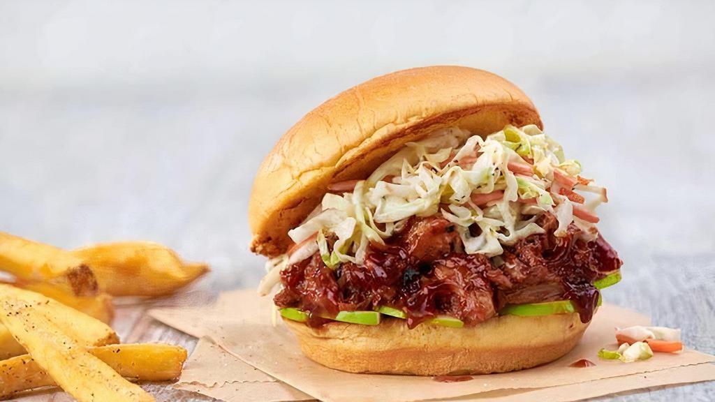 Bbq Pulled Pork Sandwich · Tender pulled pork with our house-made bbq sauce, pickles, and coleslaw served with seasoned fries.