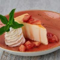 New York Cheesecake · Rich and creamy NY-style cheesecake served with fresh strawberry sauce.