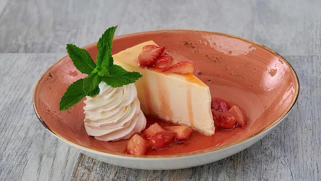 New York Cheesecake · Rich and creamy NY-style cheesecake served with fresh strawberry sauce.