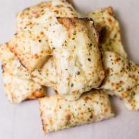 Cheesy Bread · Ten pieces cheesy bread topped with premium mozzarella, garlic sauce, fresh Parmesan cheese ...
