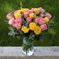 Pink And Yellow Roses Bouquet · Pink and Yellow Roses Bouquet with greenery in a clear glass vase.