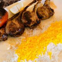 Lamb Chops · Marinated lamb chops grilled served with basmati rice with saffron, grilled tomato, and Anah...