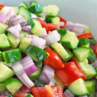 Shirazi Salad · Diced tomatoes, onions, cucumbers, and chopped parsley with our fresh lime, lemon juice and ...