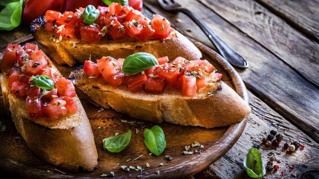 Buttercup Bruschetta · Tomato, Red Onions, Basil, Balsamic Vinegar, Olive Oil & Sourdough Bread.