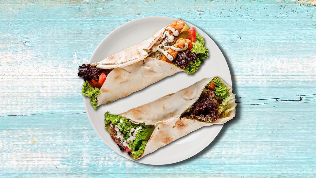 Falafel Fantasy Wrap  · Comes with seasoned falafel, spinach, tomatoes, cucumbers, black olives, red onions, feta cheese, tzatziki, and green seasoning wrapped to perfection.