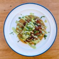 Adobada Street Taco · Adobada, cilantro sauce, onions, cilantro, and guacamole on corn tortillas.