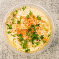Hummus · Garbanzo beans, olive oil, tahini sauce, topped with fresh chopped parsley.