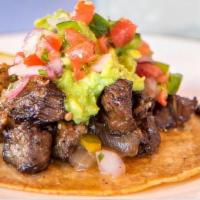 Carne Asada Tacos (2) · grilled hanger steak, guacamole, fresca and quemada salsas. served with organic corn tortill...