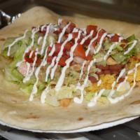 Burrito · Large flour tortilla wrapped around your choice of meat, rice, refried beans, cilantro, onio...