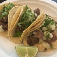 Tacos · Taco-sized corn tortillas served with choice of meat. Topped with cilantro, onion, and hot s...