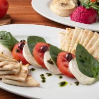 Caprese Appetizer · 4 Slices of Fresh Mozzarella, Roma Tomatoes, Fresh Basil, and Kalamata Olives Drizzled With ...