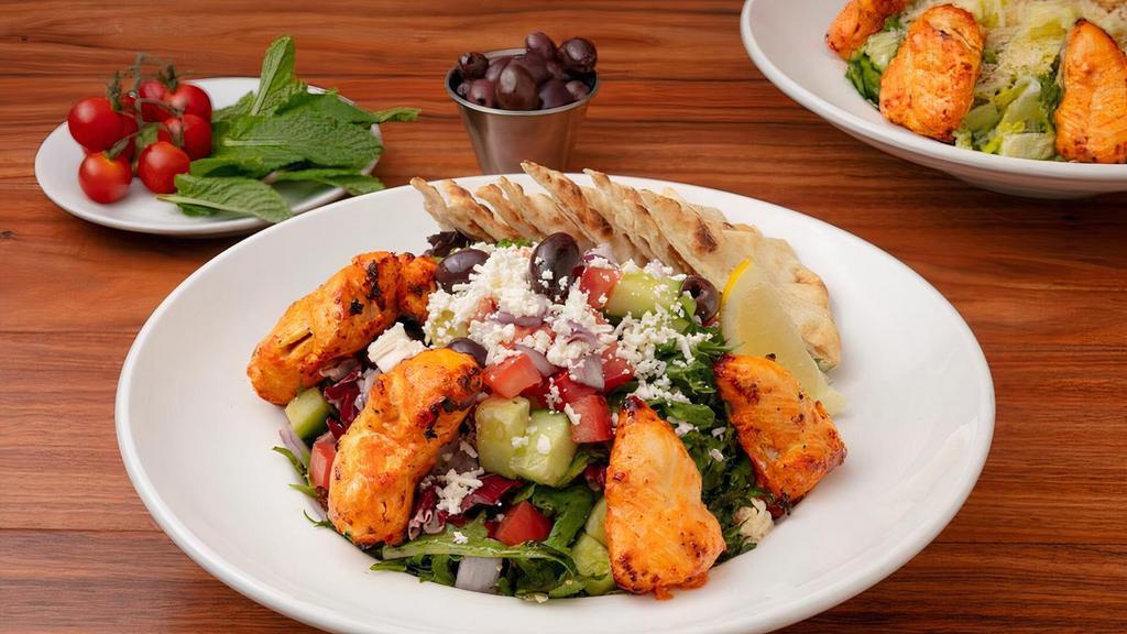 Mediterranean Greek Salad · Mixed Greens, Onions, Roma Tomatoes, Cucumbers, Kalamata Olives and Feta Cheese with Balsamic Vinaigrette. Served with Warm Pita Bread.