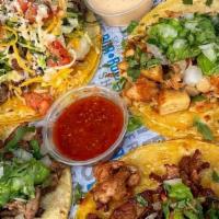 Pollo Asado Taco · Marinated chicken, guacamole, diced onions, cilantro with soft corn tortilla