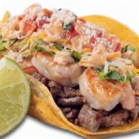 Surf-N-Turf Taco · Grilled shrimp, angus steak, lettuce, cheese, salsa fresca, special sauce and cotija cheese ...
