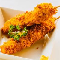 Kushikatsu / 串カツ · Panko breaded pork and onion skewer.