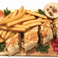 Beef Shawarma Plate · Sliced wrap of a Beef Shawarma served with Hummus and Fries.