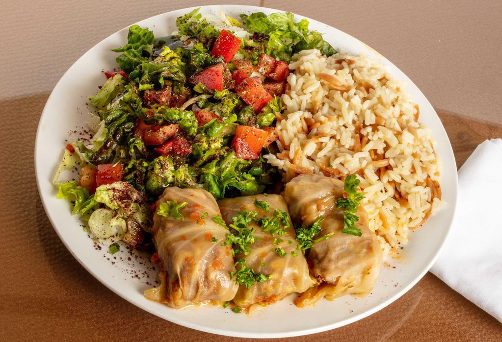 Dolma (Cabbage) · Ground beef meat mixed with rice, parsley, onions, special spices, tomatoes, bell peppers, and wrapped in boiled cabbage leaves.