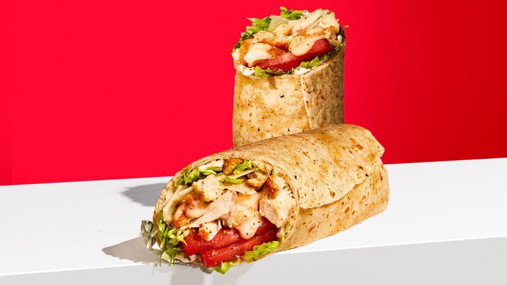 Chicken Caesar Wrap · SEASONED CHICKEN, Parmesan Cheese, Lettuce, Tomato, Mayo, Caesar Dressing, Ranch seasoning, Mini Croutons, wrapped in a Garlic & Herb Wrap. Chicken is not all-natural. At participating locations for a limited time.