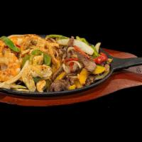 Trio Fajitas · Chicken, asada, and shrimp fajitas with onions and bell peppers