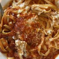 Chicken Parmesan · Tender chicken breast on a bed of fettuccine smothered with provolone cheese and our homemad...