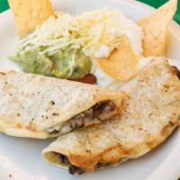 Mulitas · Two corn tortillas with steak, cheese, and bacon topped with sour cream and guacamole.